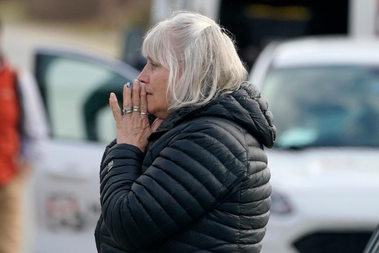 A woman reacts at the scene of a multiple shooting, Tuesday, April 18, 2023, in Bowdoin, Maine (AP)