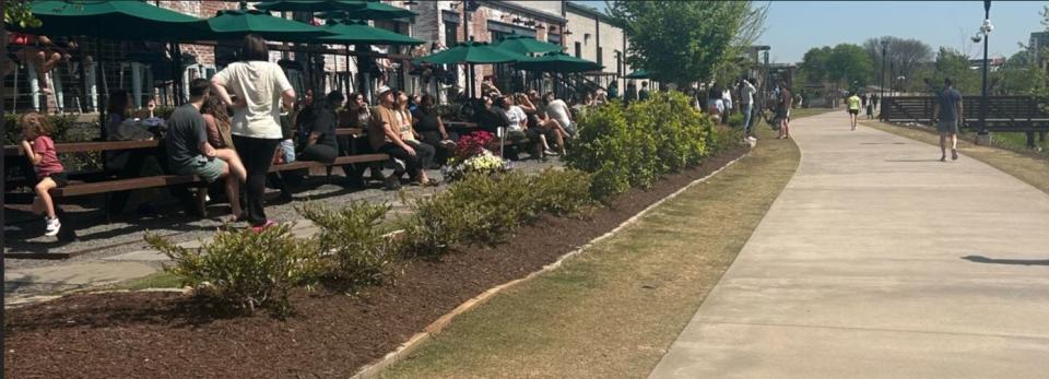 People gathering at The Commons at Unity Park to watch the solar eclipse.