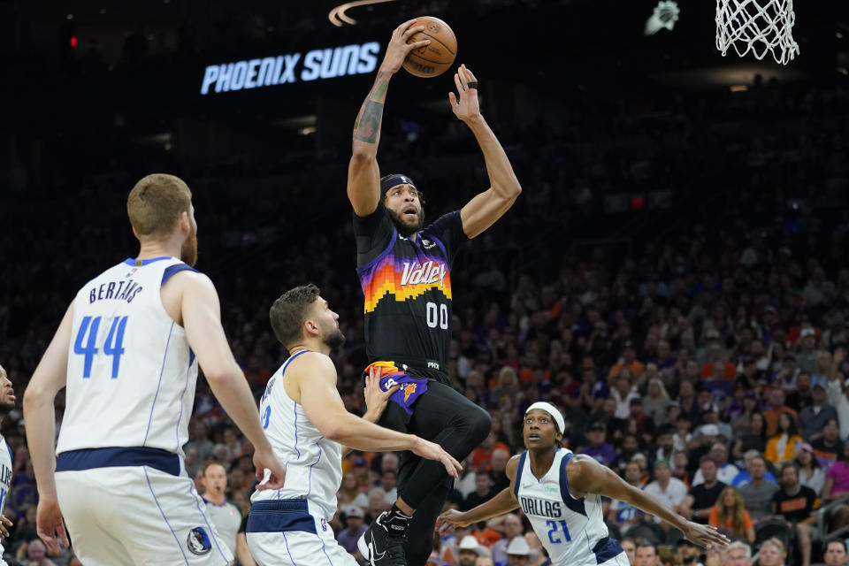 Phoenix Suns center JaVale McGee (00) dunks over Dallas Mavericks forward Maxi Kleber during the first half of Game 7 of an NBA basketball Western Conference playoff semifinal, Sunday, May 15, 2022, in Phoenix. (AP Photo/Matt York)