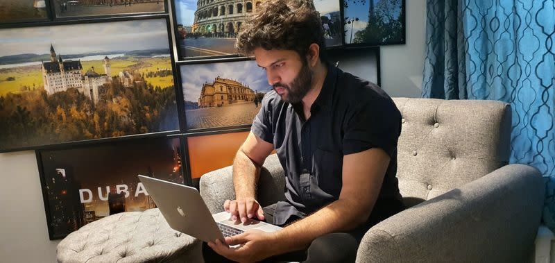 Zoraiz Riaz, who admins a Facebook group called Corona Recovered Warriors! to coordinate convalescent plasma donations, works on a computer at his residence in Lahore