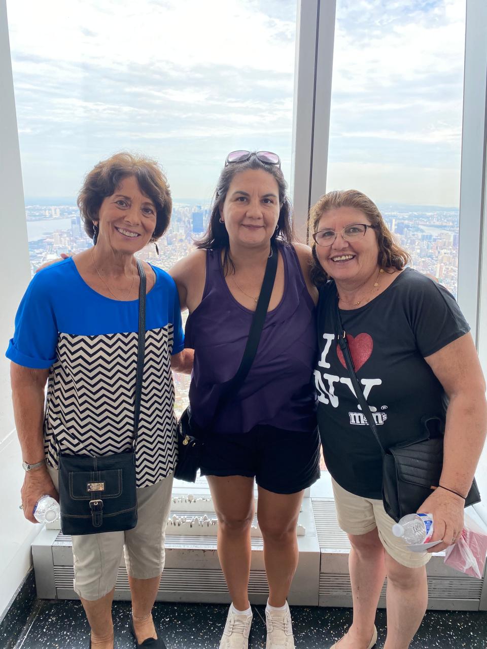 Rachel Smolka (center) of Staten Island, New York, is sandwiched between her adoptive mother, Irene Napolitano (L), and her birth mother from Chile, Karina del Carmen Valdes Lara (R), in New York City on Aug. 14, 2023. The mothers met each other for the first time last month after Smolka found out she was among Chile's stolen children. Monday marks both the 22nd anniversary of the 2001 terror attacks on the U.S. and the 50th anniversary of the coup in Chile that led to the bloody dictatorship of Augusto Pinochet. It's a day full of meaning for Smolka.