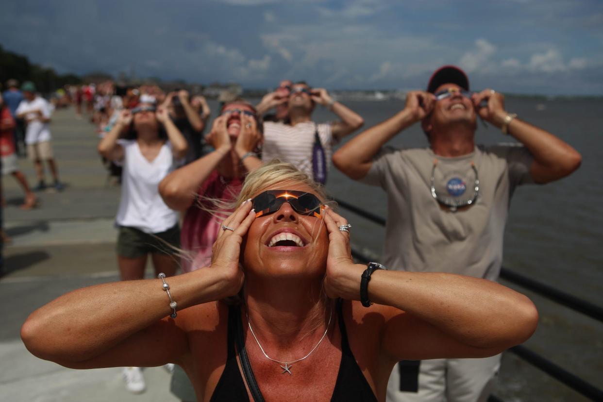 Melissa Cheatwood, from Baltimore, Md., gazes up as the eclipse enters totality in Charleston, S.C. on Aug. 21, 2017.