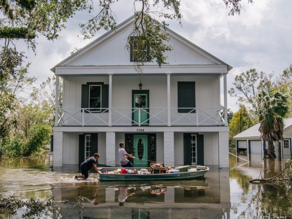 People wade through water on August 31 in Barataria, Louisiana. Hurricane Ida made landfall as a Category-4 storm in Louisiana and brought flooding and wind damage to the Gulf Coast (Brandon Bell/Getty Images)