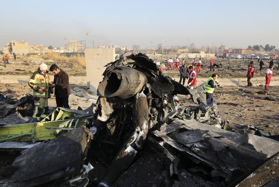 FILE - In this Jan. 8, 2020, file photo, debris at the scene where a Ukrainian plane crashed in Shahedshahr southwest of the capital Tehran, Iran. After a yearlong investigation, Iran's civil aviation agency on Wednesday released its final report on the crash of a Ukrainian passenger plane that killed 176 people last January, revealing no new details about the shootdown that has provoked outrage from affected countries and concerns from U.N. investigators. (AP Photo/Ebrahim Noroozi, File)