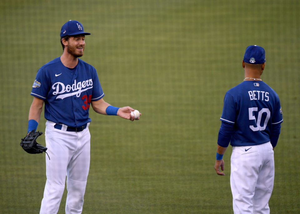 Dodgers outfielder Cody Bellinger talks with right fielder Mookie Betts.