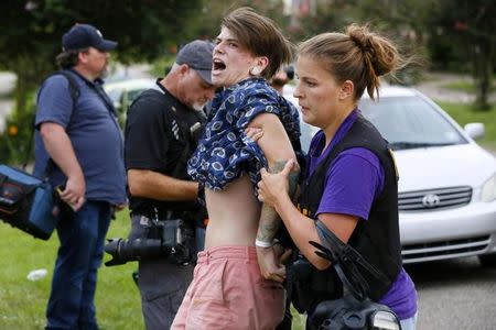 A demonstrator protesting the shooting death of Alton Sterling is detained by a law enforcement officer in Baton Rouge, Louisiana, U.S., July 10, 2016. REUTERS/Jonathan Bachman