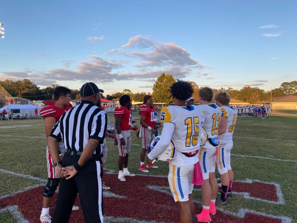 The Newberry Panthers and Williston Red Devils' captains meet at midfield ahead of their matchup on Oct. 3, 2022 at Williston's Booster Stadium.