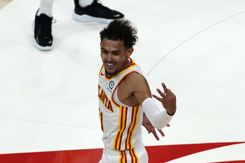 Atlanta Hawks guard Trae Young (11) reacts after an Atlanta basket in the second half of an NBA basketball game against the New Orleans Pelicans Tuesday, April 6, 2021, in Atlanta. (AP Photo/John Bazemore)