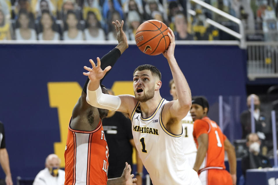 Michigan center Hunter Dickinson (1) drives on Illinois center Kofi Cockburn (21) in the second half of an NCAA college basketball game in Ann Arbor, Mich., Tuesday, March 2, 2021. (AP Photo/Paul Sancya)