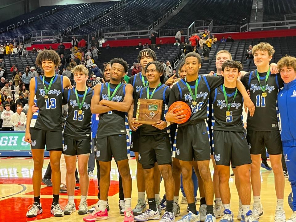 Wyoming players pose with their district championship hardware during the OHSAA Division II boys district championship games March 9, 2024 at University of Dayton Arena.