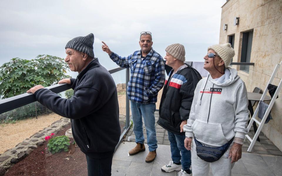 Avi Yehuda, far right, the oldest evacuee at 72, enjoys the views of the Sea of Galilee