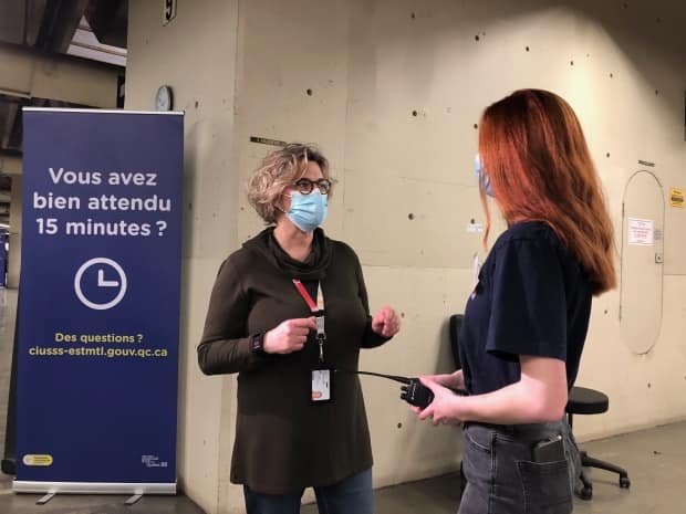  Julie Provencher, director of youth and public health services at CIUSSS de l'est de l'ile de Montreal, speaks with her 13-year-old daughter who volunteered to help out on Monday.