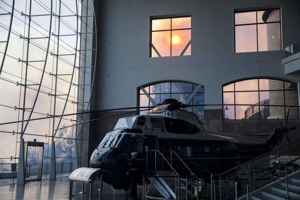 Marine One stands on display in the Ronald Reagan Presidential Library as smoke rises outside during the Easy Fire in Simi Valley, Calif. on Oct. 30, 2019. Â (Photo: Patrick T. Fallon/Bloomberg via Getty Images)