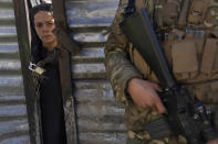 FILE - A boy looks through a locked door as he waits his turn to receive food supplies during an aid distribution for families in need in Kabul, Afghanistan, Wednesday, Feb. 16, 2022. Some 1.6 billion people in 94 countries face at least one dimension of the crisis in food, energy and financial systems, according to a report last month by the Global Crisis Response Group of the United Nations Secretary-General. (AP Photo/Hussein Malla, FIle)