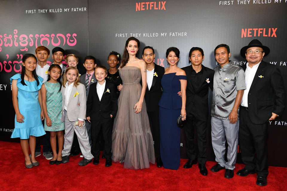 <p><em>First They Killed My Father — based on </em>Cambodian author Loung Ung’s book about the horrors she suffered under the rule of the deadly Khmer Rouge — was a family affair for Angelina. She directed the film and let <a rel="nofollow" href="https://www.yahoo.com/entertainment/maddox-jolie-pitt-praises-apos-211455644.html" data-ylk="slk:16-year-old Maddox, whom she adopted from Cambodia, executive-produce, while Pax, 13, served as a set photographer;elm:context_link;itc:0;sec:content-canvas;outcm:mb_qualified_link;_E:mb_qualified_link;ct:story;" class="link  yahoo-link">16-year-old Maddox, whom she adopted from Cambodia, executive-produce, while Pax, 13, served as a set photographer</a>. So the actress has been bringing her whole crew out in support of the film, including to the NYC premiere on Sept. 14, where they posed with Ung and various stars and producers of the flick. (Photo: Dia Dipasupil/Getty Images) </p>