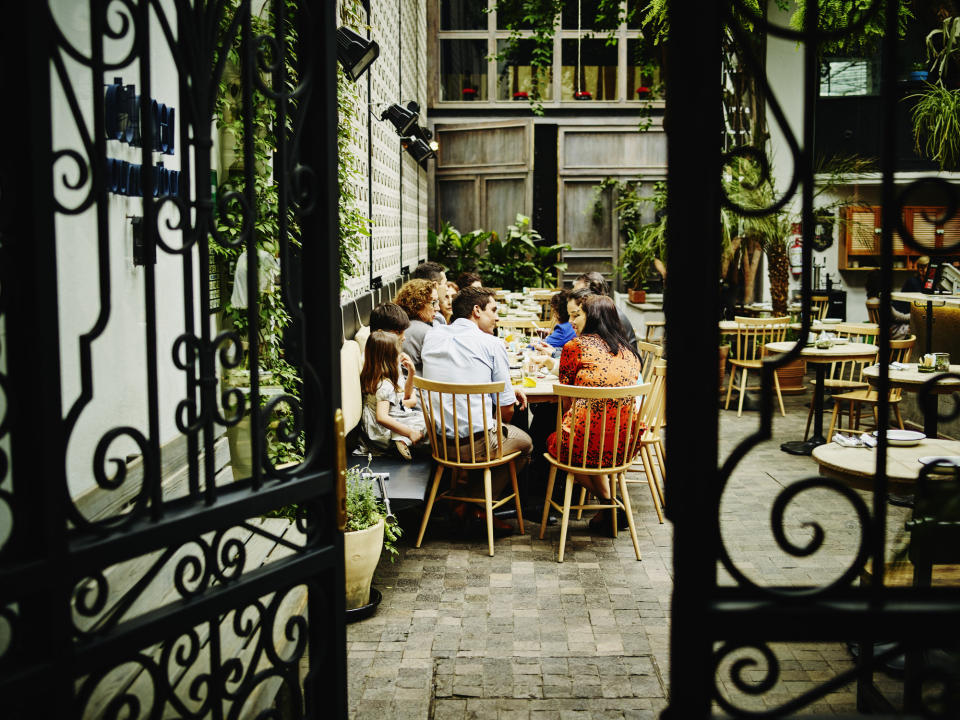 Multi-generational family dining at table in restaurant.