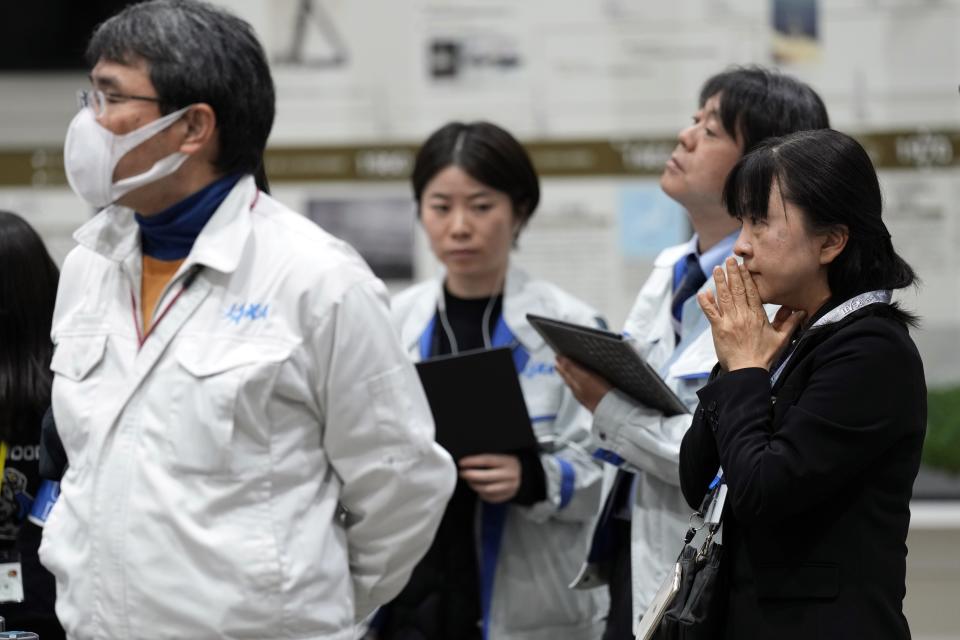 Staff of Japan Aerospace Exploration Agency (JAXA) watch a live streaming of the pinpoint moon landing operation by the Smart Lander for Investigating Moon (SLIM) spacecraft at JAXA's Sagamihara Campus Saturday, Jan. 20, 2024, in Sagamihara near Tokyo. (AP Photo/Eugene Hoshiko)