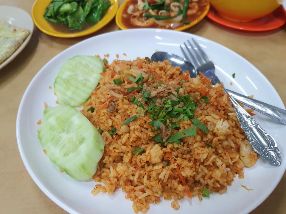 Indonesian fried rice called nasi goreng, served with sliced cucumber