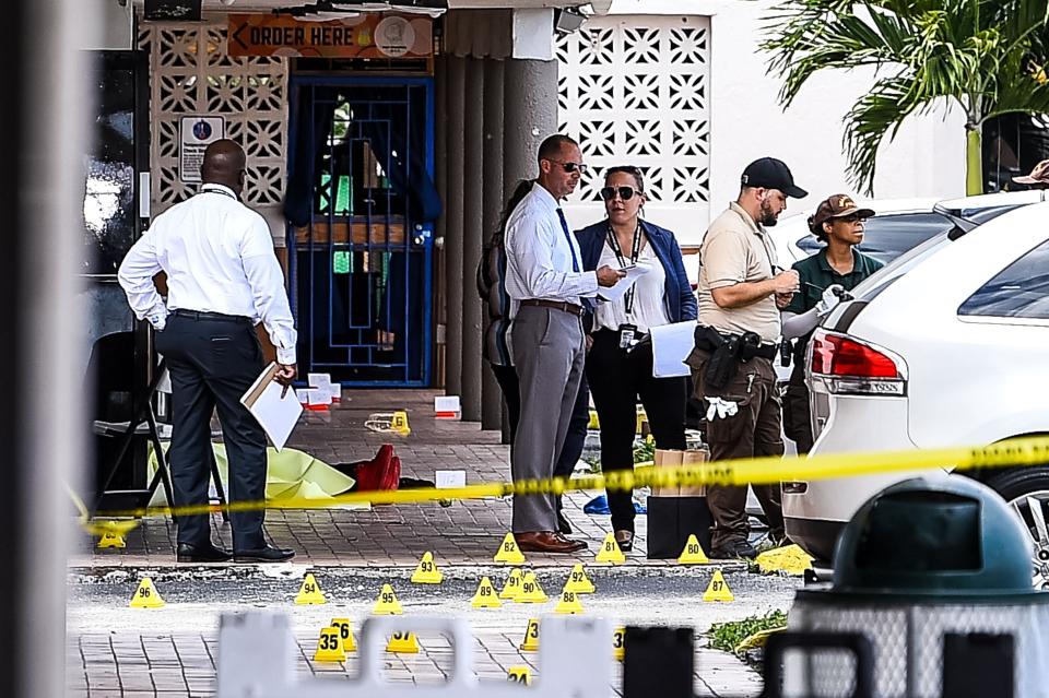 Miami Dade police officers are seen at the scene of a mass shooting that left two people dead and 21 others injured. A reward of $160,000 is being offered for information leading to the arrest and conviction of those involved. (Photo: CHANDAN KHANNA via Getty Images)