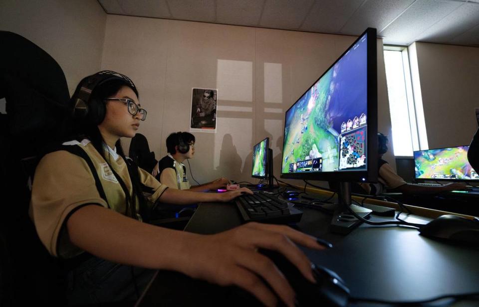 Shirley Huang, left, Jason Huang and other members of the Enochs High School esports team play a League of Legends video game match against Ripon High at Enochs High School in Modesto, Calif., Tuesday, Sept. 19, 2023.