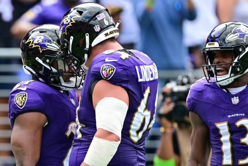 Baltimore Ravens running back J.K. Dobbins (L) reacts with center Tyler Linderbaum (C) after a touchdown against the Houston Texans on Sunday at M&T Bank Stadium in Baltimore. Photo by David Tulis/UPI