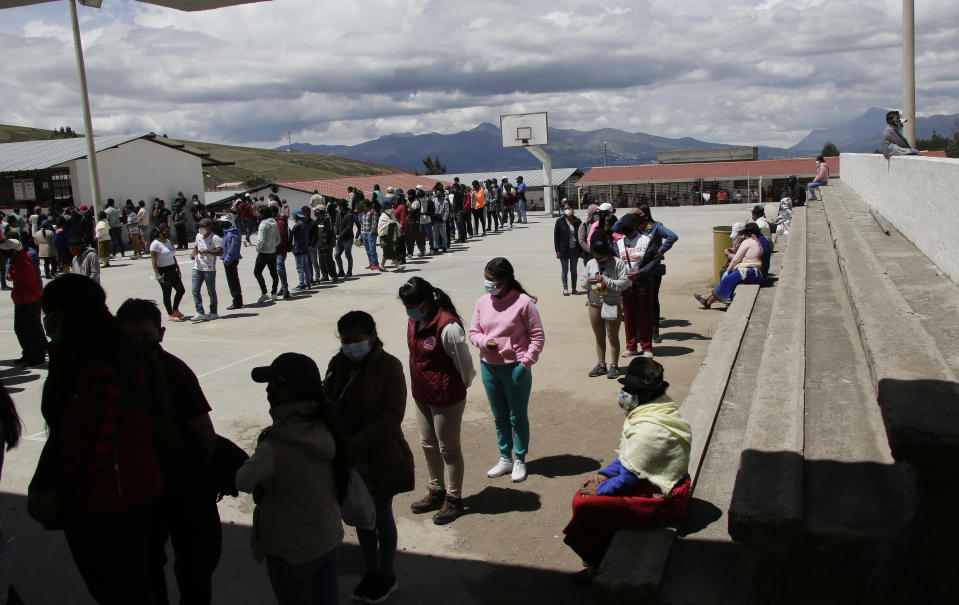 People line up to cast their ballots in Cangahua, Ecuador, Sunday, Feb. 7, 2021. Ecuadoreans went to the polls in first-round presidential legislative elections. (AP Photo/Dolores Ochoa)