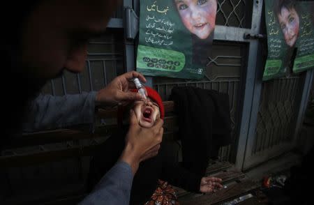 A girl receives polio vaccine drops at a government children's hospital in Peshawar, March 3, 2015. REUTERS/Fayaz Aziz