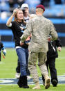 <p>Andrea Jorgensen, left, reacts to a surprise reunion with her husband, U.S. Army Capt. Joe Jorgensen, who had been deployed to Iraq, during the Panthers’ game against the Titans. The Tennessee Titans defeated the Carolina Panthers, 30-3, at Bank of America Stadium in Charlotte, North Carolina, on Sunday, November 13, 2011. (David T. Foster III/Charlotte Observer/MCT) </p>