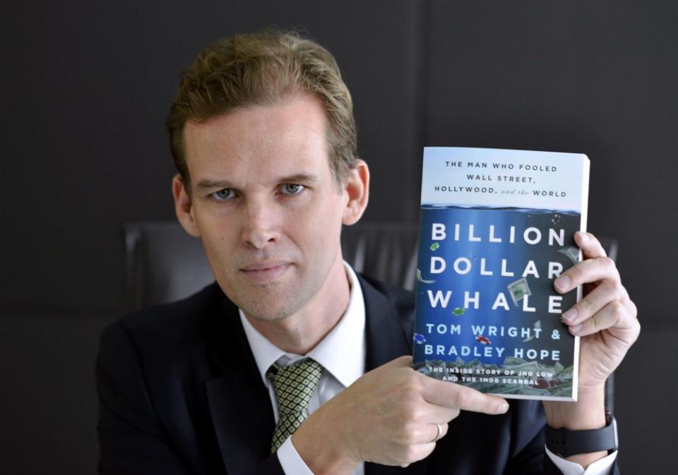 Tom Wright (pic) poses for a photo with his book ‘Billion Dollar Whale’, which he co-wrote with Bradley Hope, September 25, 2018. ― Picture by Ham Abu Bakar