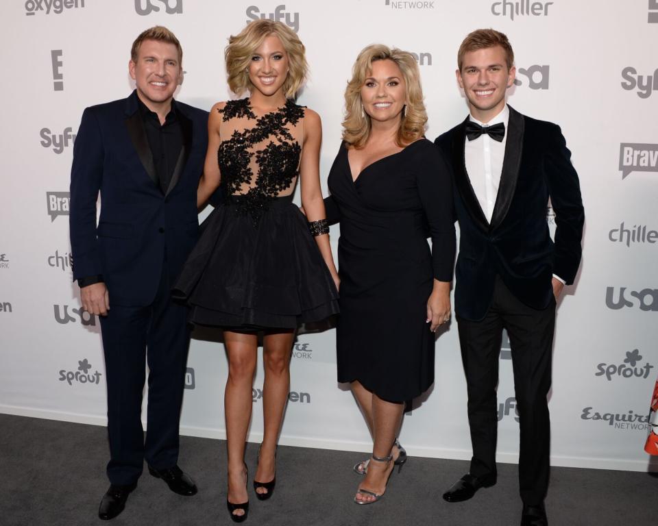 Todd Chrisley, Savannah Chrisley, Julie Chrisley and Chase Chrisley posing for pictures in in black formal wear