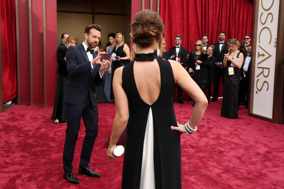 Jason Sudeikis, left, takes a cell phone photo of Olivia Wilde as they arrive at the Oscars on Sunday, March 2, 2014, at the Dolby Theatre in Los Angeles. (Photo by Matt Sayles/Invision/AP)