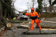 <p>A worker removes a fallen tree blocking a road on Foxholl Road as high-wind weather conditions continue in Washington, March 2, 2018. (Photo: Yuri Gripas/Reuters) </p>