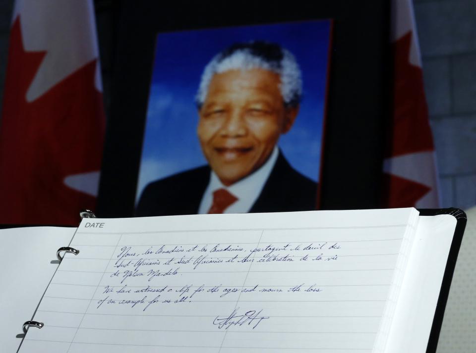 A message left by Canada's PM Harper is pictured in a book of condolence for former South African President Nelson Mandela on Parliament Hill in Ottawa