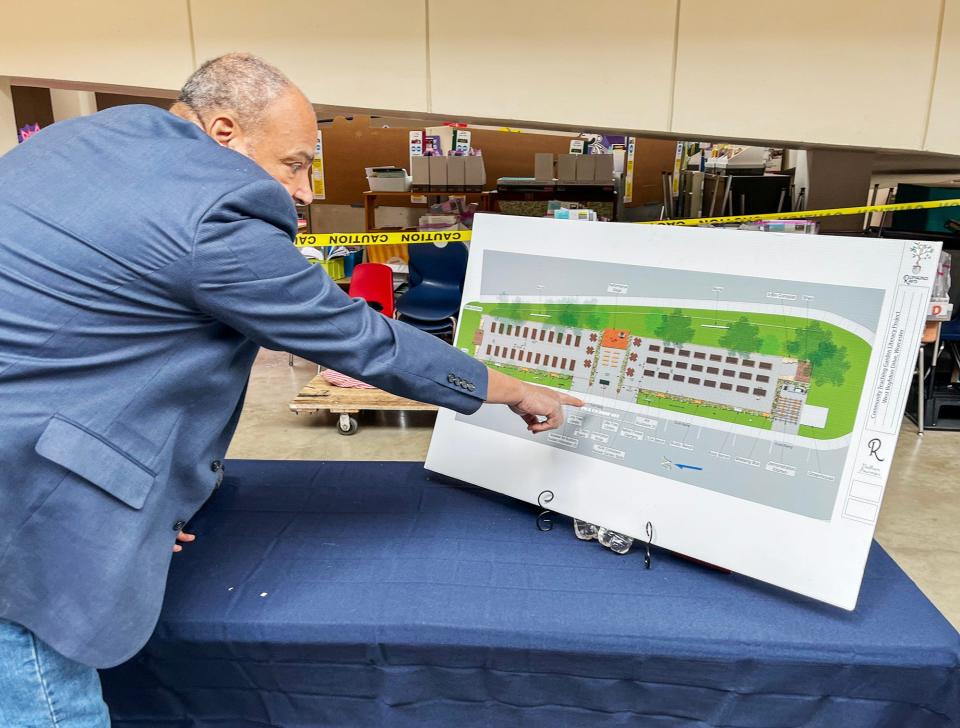 Carl Gomes shows off his plans for Indian Lake Community Association's Teaching Garden expansion.