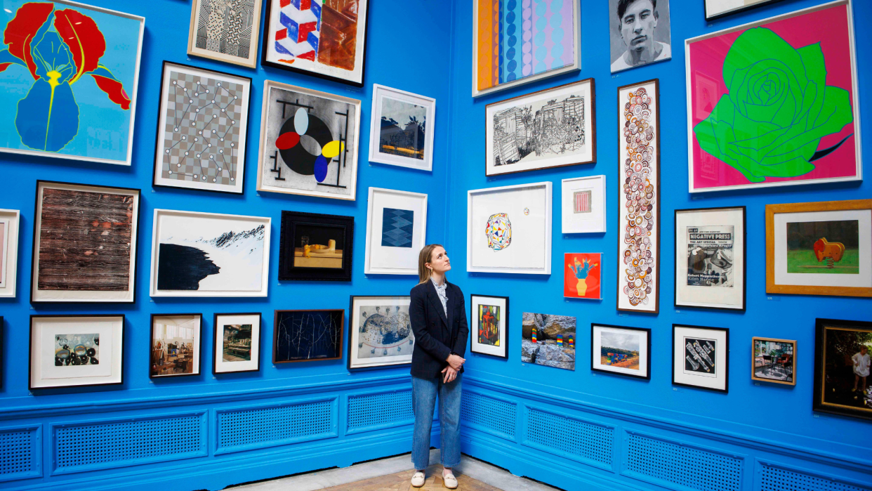  A visitor looks at a painting during the summer exhibition at the Royal Academy. . 