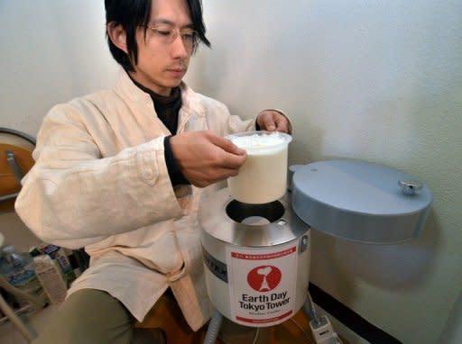 Hidetake Ishimaru, a representative of a firm which checks for radiation levels, demonstrates how to use a scintillator to measure radiation levels of a sample of milk at his shop in Tokyo. For Japanese shoppers, food safety was taken for granted until the Fukushima crisis