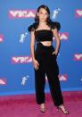 <p>The actress wore a Black Rosie Assoulin cutout jumpsuit to attend the 2018 VMAs in New York City in August. </p>