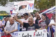 Cuban Americans protest the Cuba national baseball team playing at the World Baseball Classic game, Sunday, March 19, 2023, in Miami. Cuba faces U.S. in a quarterfinal game. (AP Photo/Marta Lavandier)