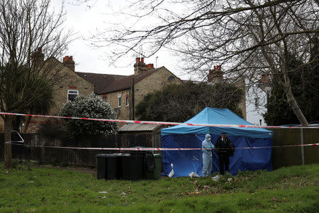 A forensic officer talks to a policeman outside a forensics tent at a property where the body of Laureline Garcia-Bertaux was found in Kew, London, Britain March 7, 2019. REUTERS/Simon Dawson