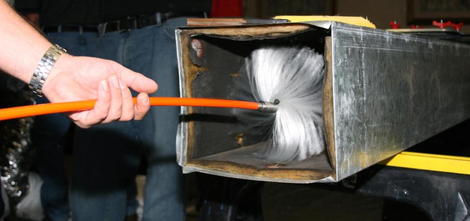 This undated publicity photo provided by NADCA shows a technician using a brush to clean ductwork. If you want to freshen up the air in your home and make your heating and cooling systems work more efficiently, you might consider having the ductwork cleaned. (AP Photo/NADCA)