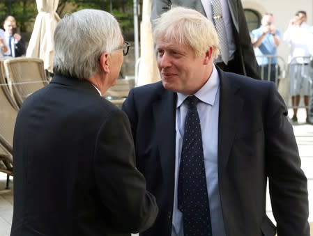 British Prime Minister Boris Johnson shakes hands with European Commission President Jean-Claude Juncker during a meeting in Luxembourg