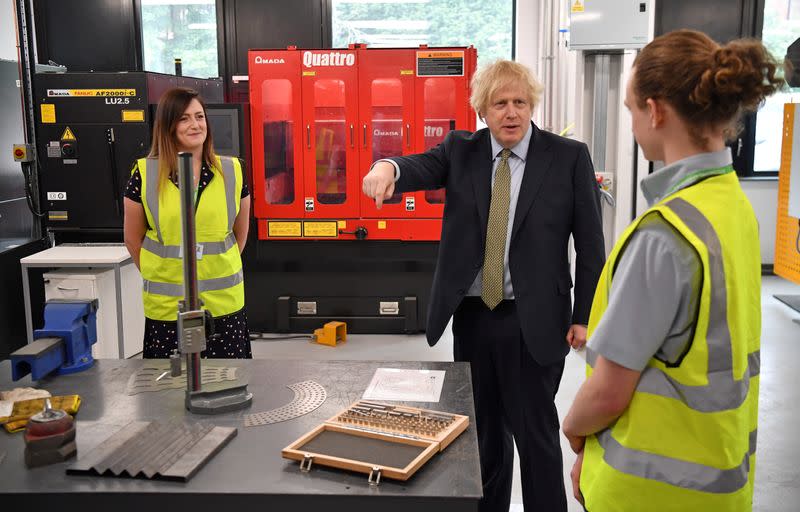 Britain's Prime Minister Boris Johnson gestures as he speaks with construction apprentices at The Dudley Institute of Technology in Dudley