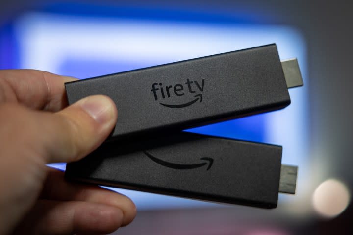 Two Amazon Fire TV Stick 4K Max sticks in hand.