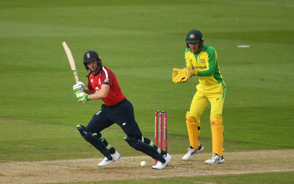 Jos Buttler of England(L) plays a shot as Alex Carey of Australia(R) looks on during the 2nd Vitality International Twenty20 match between England and Australia at The Ageas Bowl on September 06, 2020 in Southampton, England.  - GETTY IMAGES