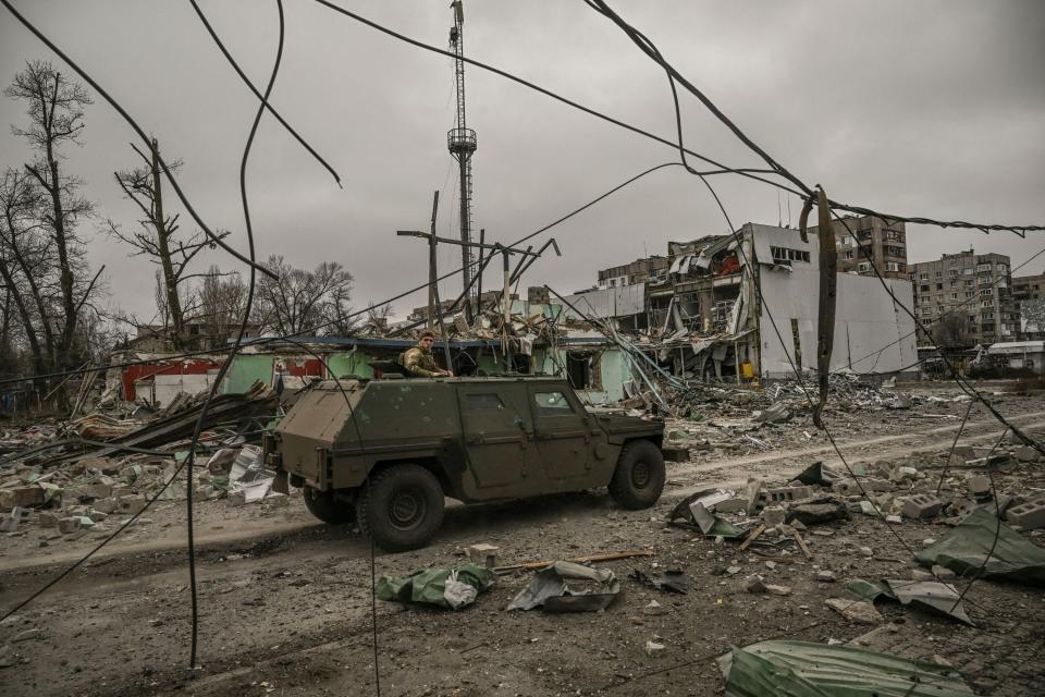 A military vehicle drives through an area destroyed after a strike, in the city of Avdiivka, Donetsk Oblast, on March 18, 2023.