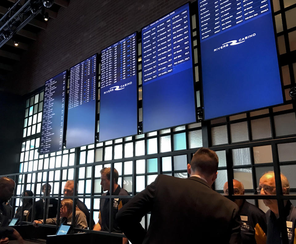 Employees at Rivers Casino and Resort prepare for the opening of its sports betting lounge in Schenectady, N.Y., Tuesday, July 16, 2019. New York joined the growing list of states allowing wagering on sports after the upstate casino cut the ribbon on a new betting lounge Tuesday and took its first bet — $20 on the Seattle Mariners. (AP Photo/David Klepper)