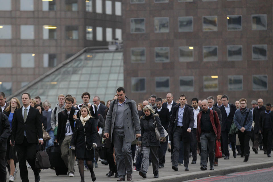 FILE - This Oct. 25, 2012 file photo shows workers walking across London Bridge to their work places in the City of London. For visitors on a literary tour of London, Charles Dickens' "Great Expectations" included a scene in which Pip crossed the bridge in great despair after learning that Estella was to be married to Drummle. (AP Photo/Sang Tan, file)