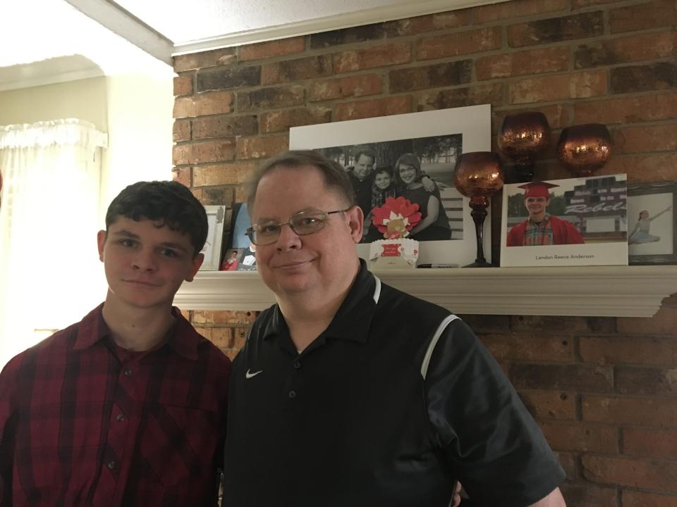 Landon and Robert Anderson stand in their Pineville home March 6, less than a week after mother and wife Monica Anderson died. Before she died, her last wish of seeing Landon graduate from high school was fulfilled.