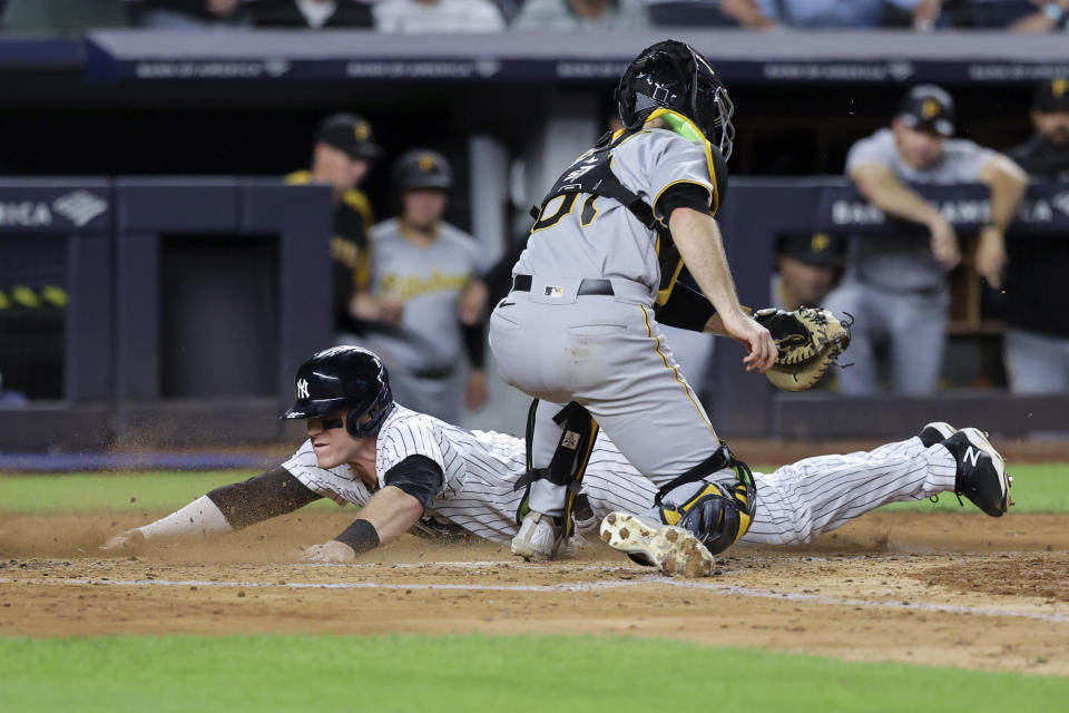 New York Yankees' Harrison Bader scores ahead of the tag by Pittsburgh Pirates catcher Jason Delay (61) during the fifth inning of a baseball game Tuesday, Sept. 20, 2022, in New York. (AP Photo/Jessie Alcheh)