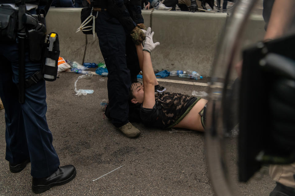 HONG KONG, HONG KONG - JUNE 12:  A protester is arrested during a protest against a proposed extradition law on June 12, 2019 in Hong Kong, Hong Kong. Large crowds of protesters gathered in central Hong Kong as the city braced for another mass rally in a show of strength against the government over a divisive plan to allow extraditions to China. (Photo by Billy H.C. Kwok/Getty Images)